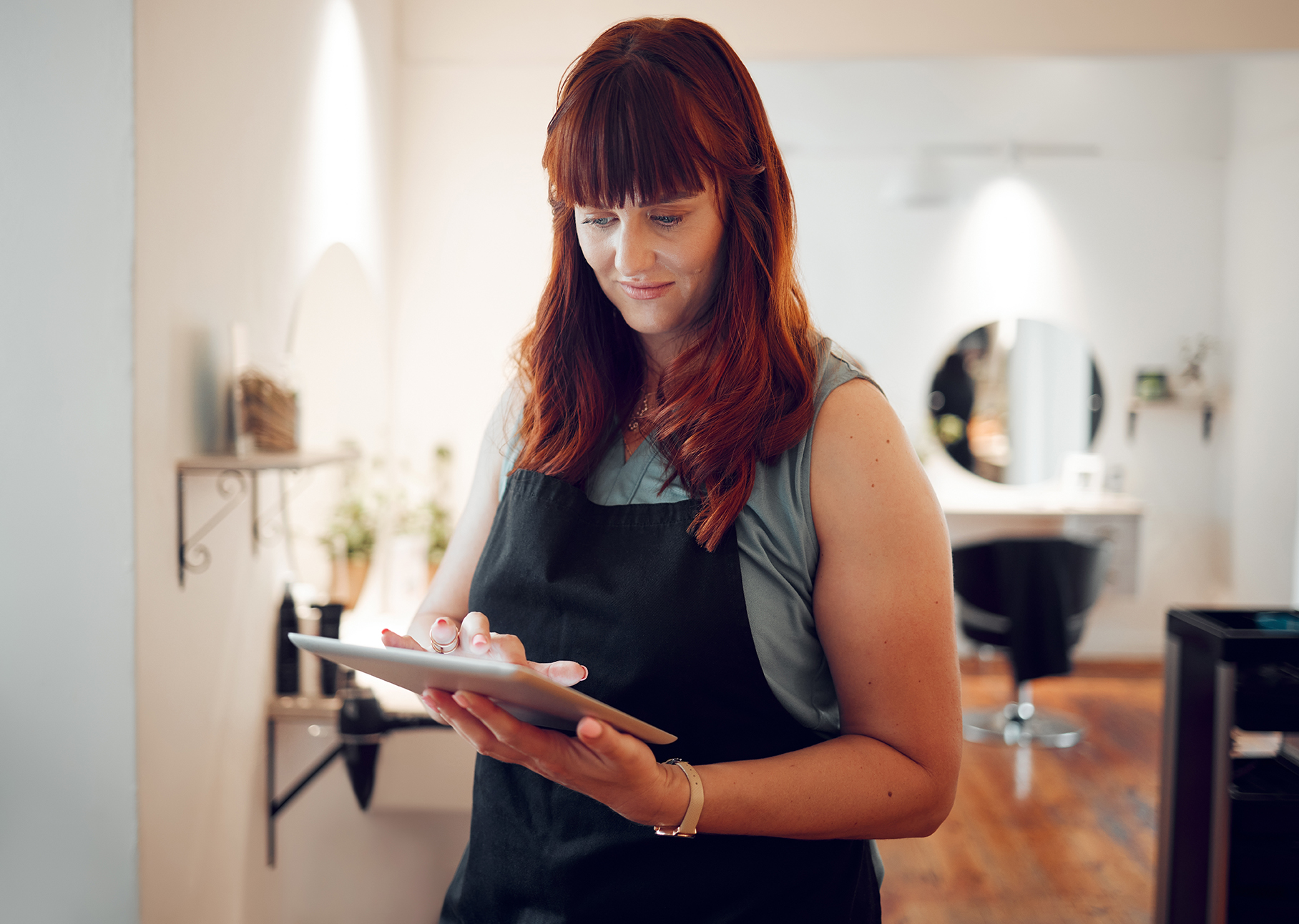 Image of a woman reading her tablet