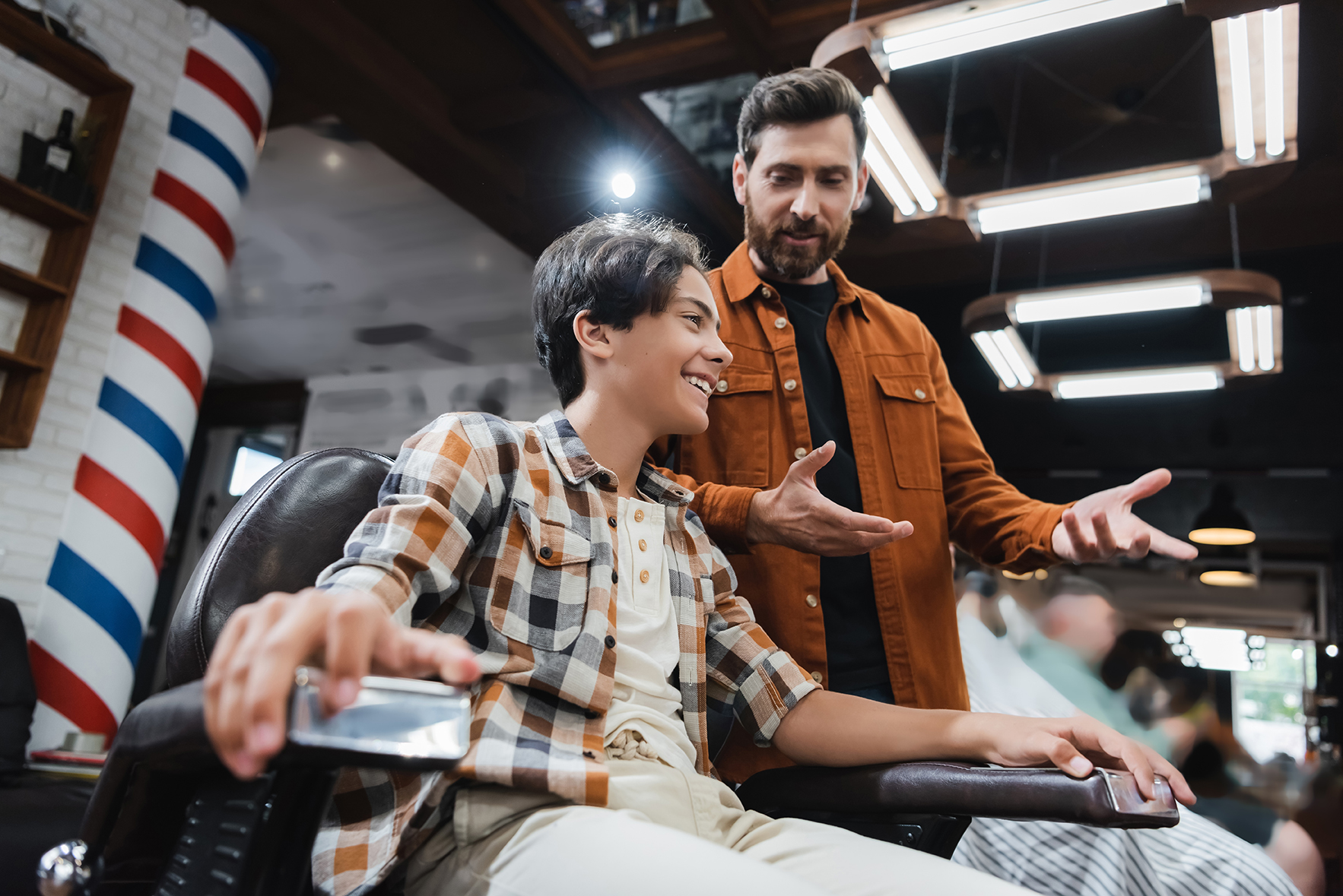 Image of barber speaking to customer